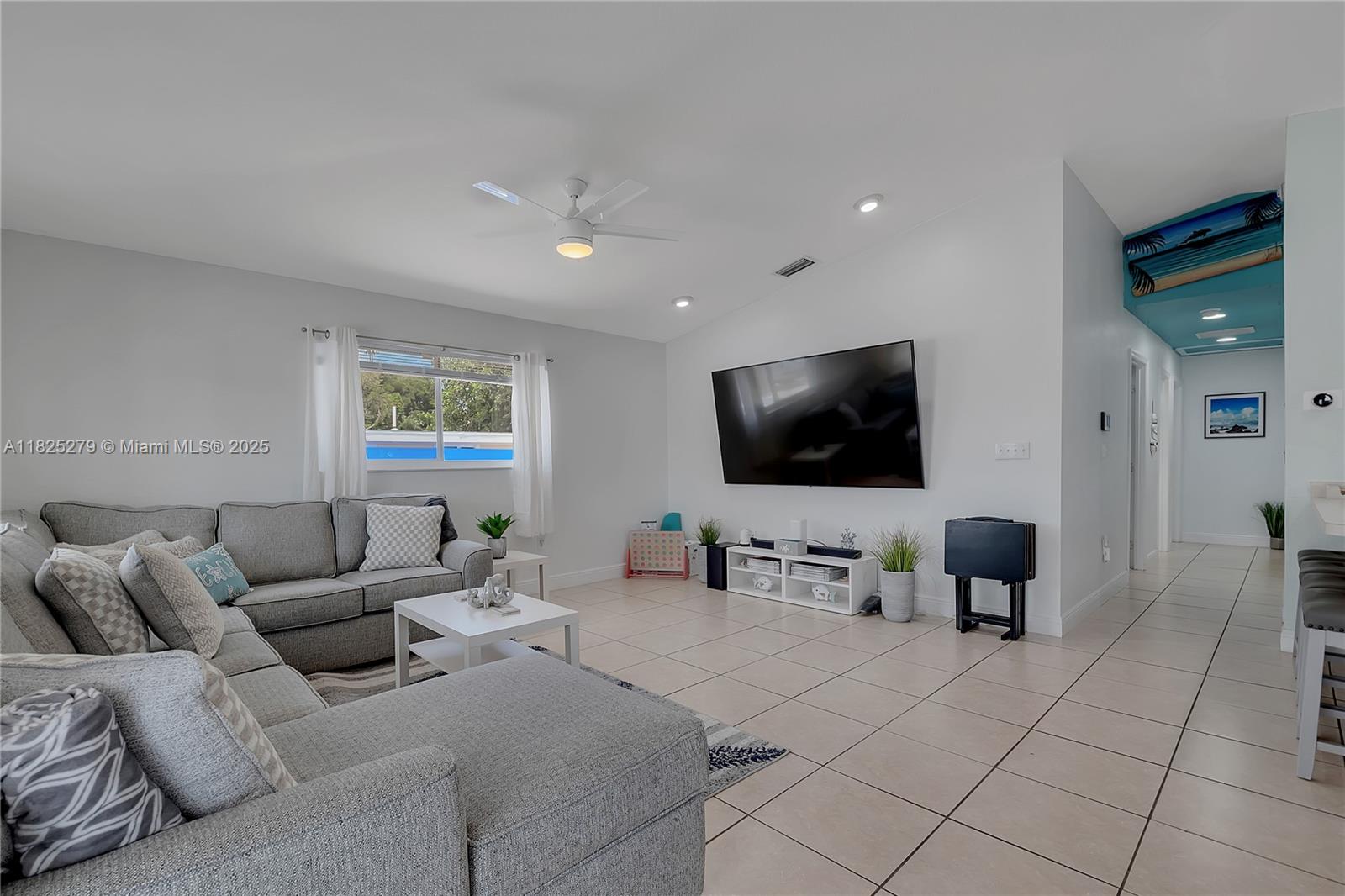 939 Plantation Road Key Largo, FL 33037 - Photo 10 of 41 a living room with furniture and a flat screen tv