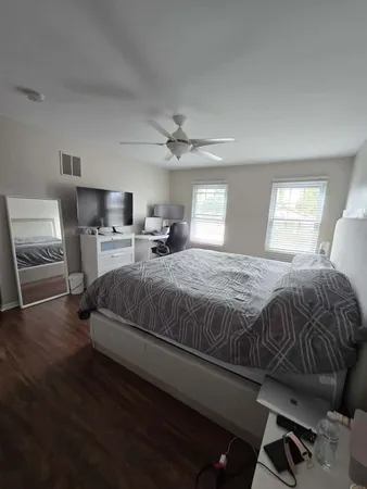 a bedroom with a bed a window and chair
