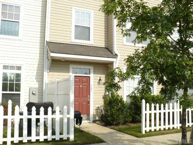 8641 Neuse Club Lane, Unit 107 Raleigh, NC 27616 - Photo 1 of 11 a front view of a house having yard
