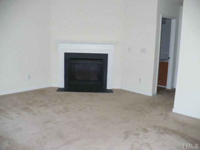 8641 Neuse Club Lane, Unit 107 Raleigh, NC 27616 - Photo 11 of 11 a view of empty room with a fireplace