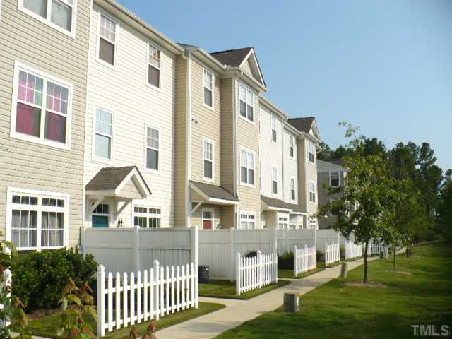 8641 Neuse Club Lane, Unit 107 Raleigh, NC 27616 - Photo 2 of 11 a front view of a building with a garden