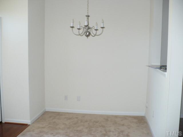 8641 Neuse Club Lane, Unit 107 Raleigh, NC 27616 - Photo 6 of 11 a view of a chandelier fan in a room