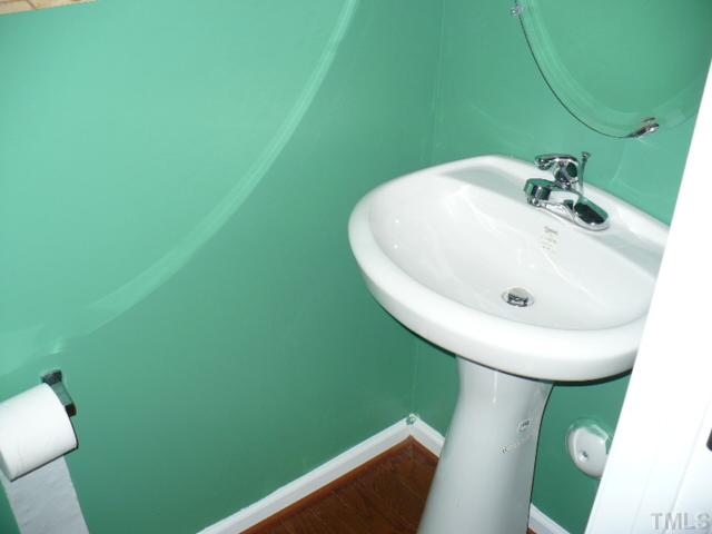 8641 Neuse Club Lane, Unit 107 Raleigh, NC 27616 - Photo 7 of 11 a bathroom with a sink and toilet
