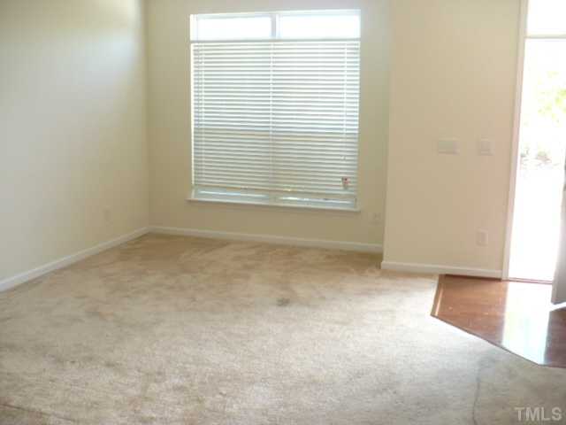 8641 Neuse Club Lane, Unit 107 Raleigh, NC 27616 - Photo 8 of 11 a view of an empty room with a window
