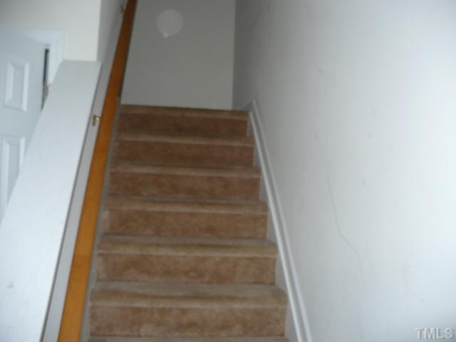 8641 Neuse Club Lane, Unit 107 Raleigh, NC 27616 - Photo 9 of 11 a view of staircase with white walls
