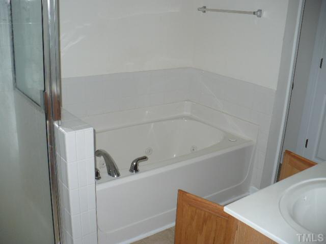 8641 Neuse Club Lane, Unit 107 Raleigh, NC 27616 - Photo 10 of 11 a bathroom with a bathtub