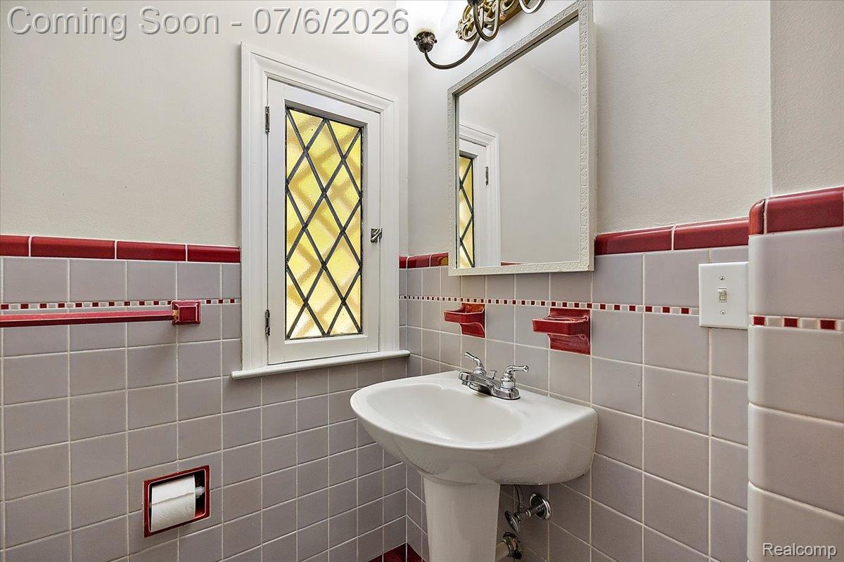 1051 Devonshire Road Grosse Pointe, MI 48230 - Photo 27 of 98 Bathroom featuring a pedestal sink, chrome faucet, and a wall-mounted mirror