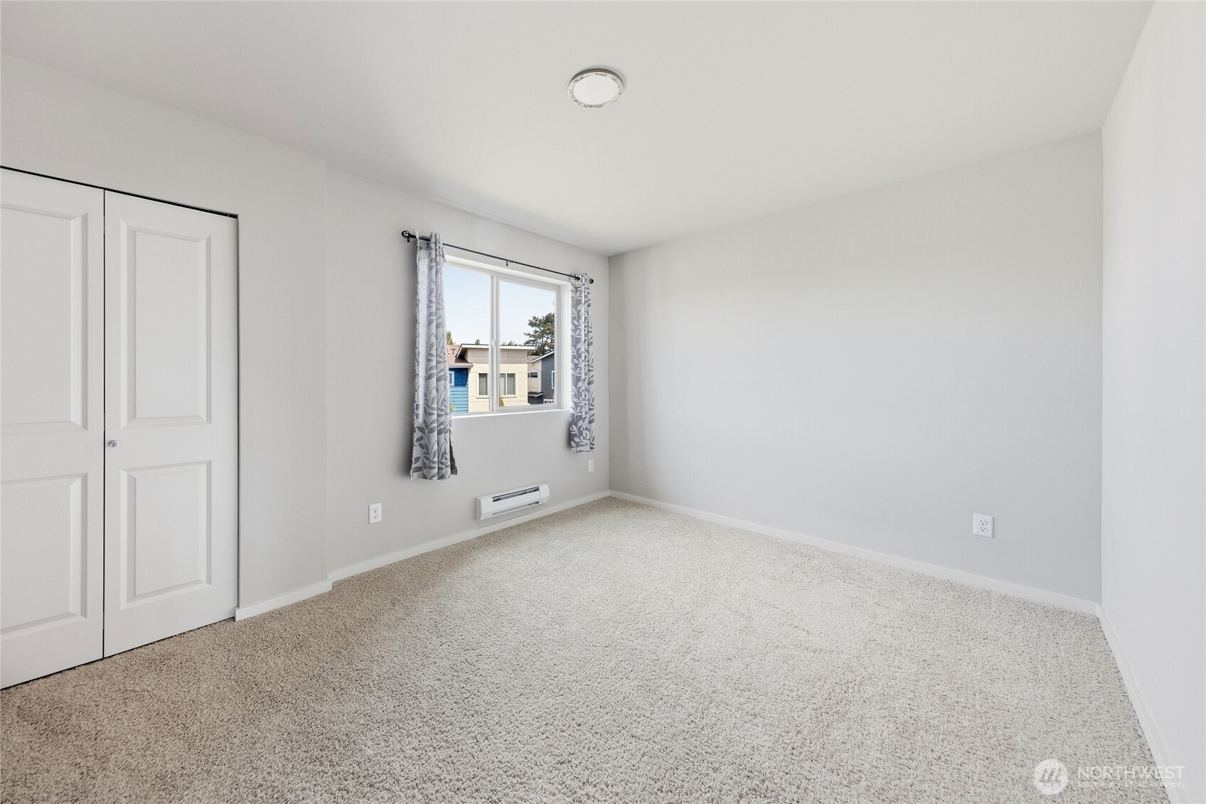 1066 Southwest 99th Place, Unit 55 Seattle, WA 98106 - Photo 11 of 21 a view of an empty room with a window