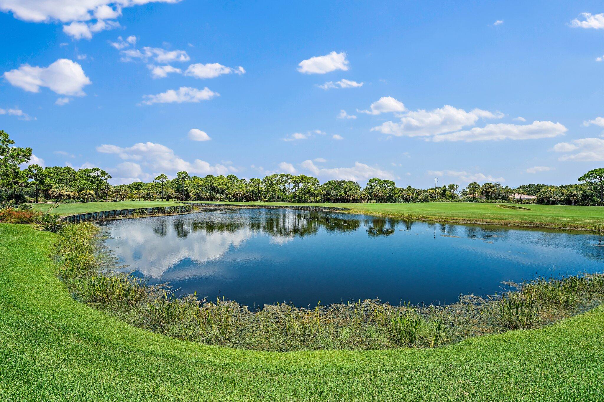 438 Red Hawk Drive Jupiter, FL 33477 - Photo 103 of 116 a view of a lake with houses in the back