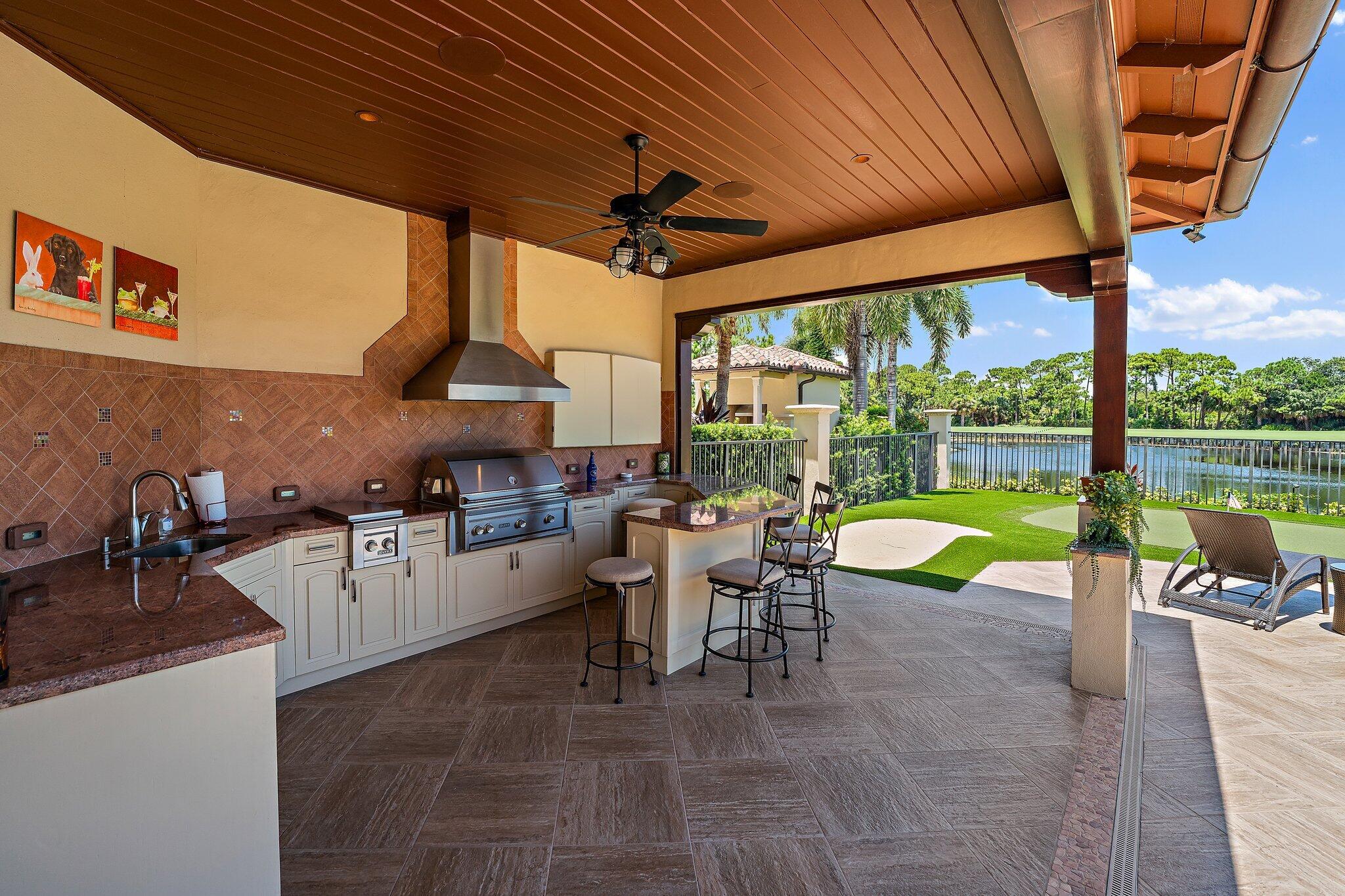 438 Red Hawk Drive Jupiter, FL 33477 - Photo 109 of 116 a view of a patio with a table chairs and a swimming pool