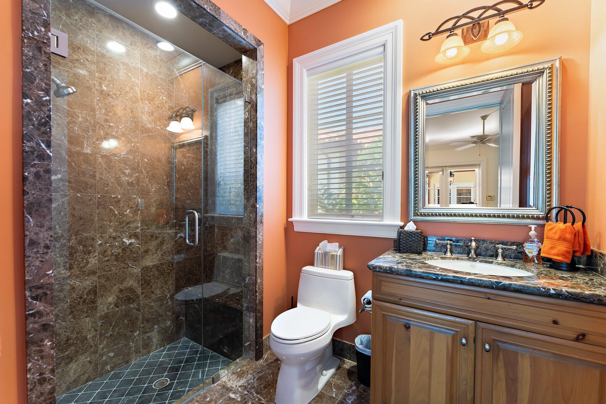 438 Red Hawk Drive Jupiter, FL 33477 - Photo 16 of 116 a bathroom with a granite countertop toilet a sink and a mirror