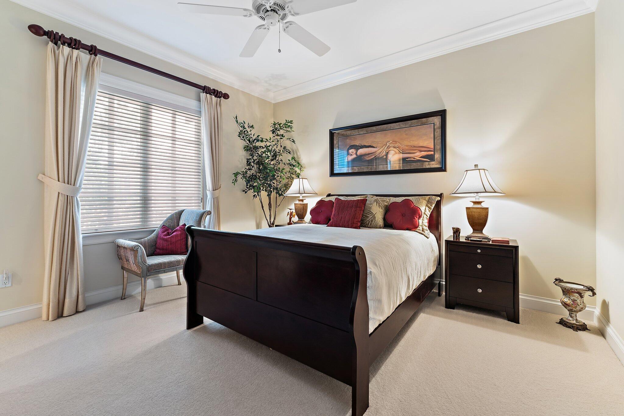 438 Red Hawk Drive Jupiter, FL 33477 - Photo 19 of 116 a bedroom with a bed and a chandelier