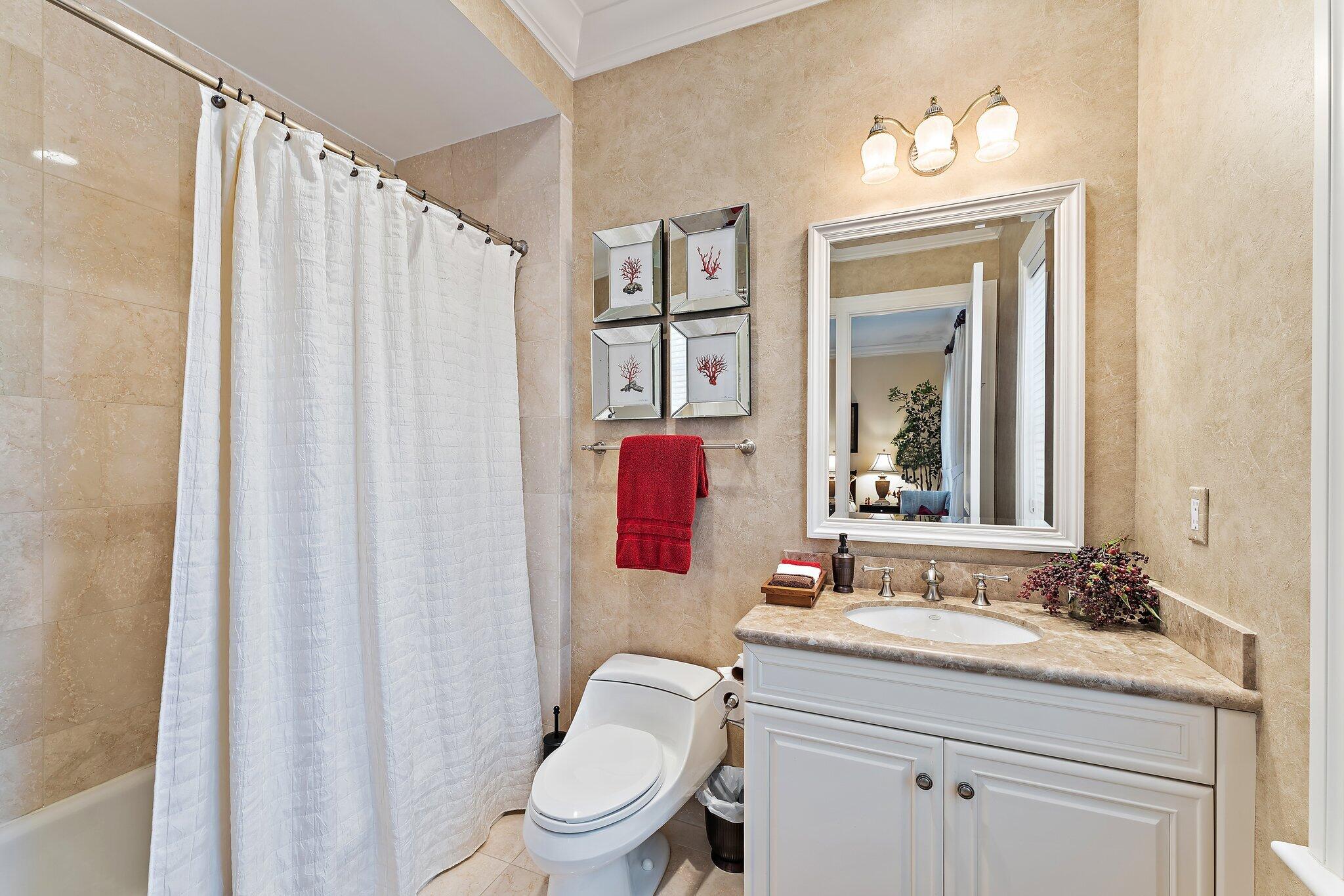 438 Red Hawk Drive Jupiter, FL 33477 - Photo 20 of 116 a bathroom with a granite countertop sink a toilet and a mirror