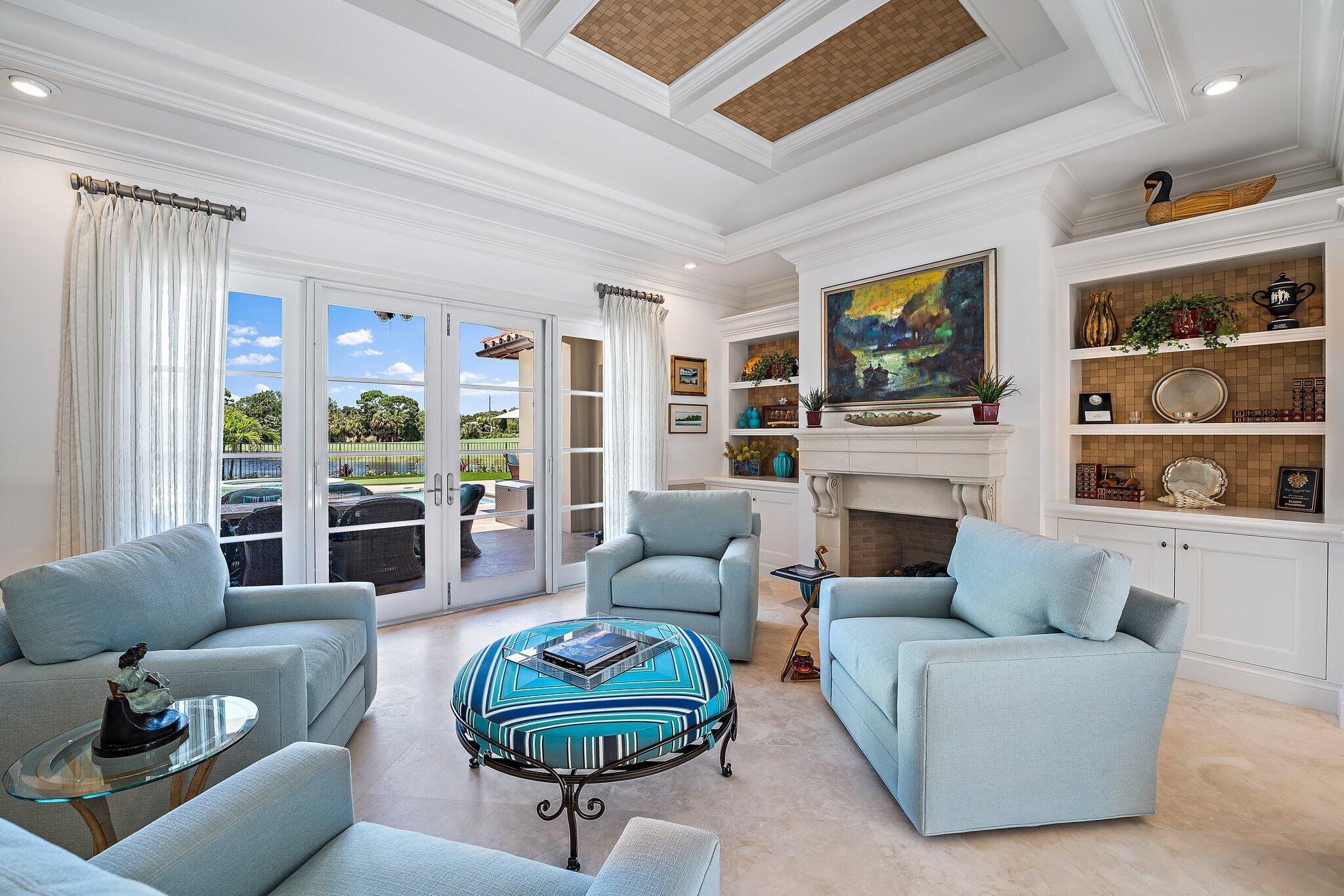 438 Red Hawk Drive Jupiter, FL 33477 - Photo 5 of 116 a living room with furniture a rug and a fireplace