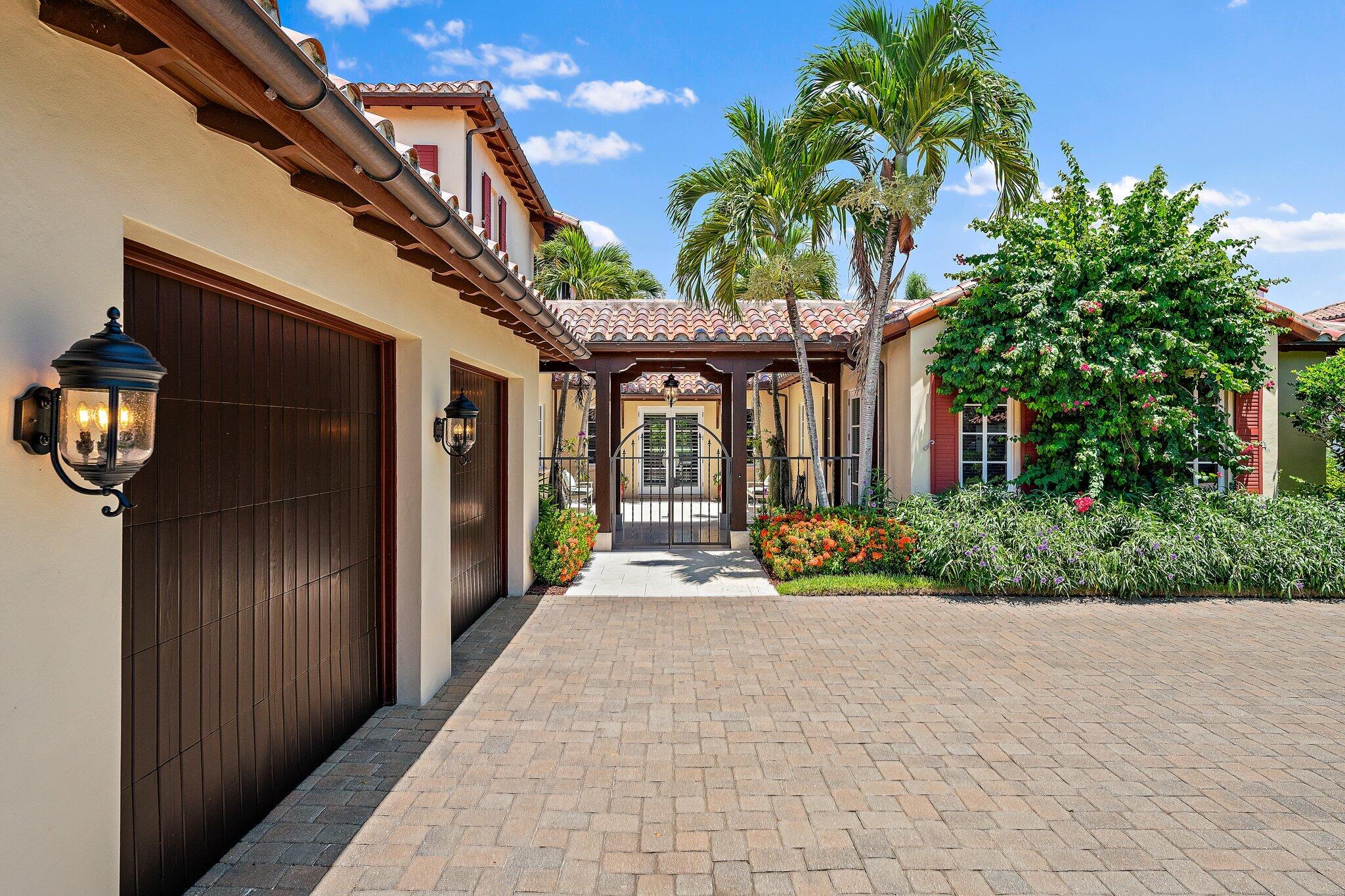 438 Red Hawk Drive Jupiter, FL 33477 - Photo 51 of 116 a front view of a house with a garden