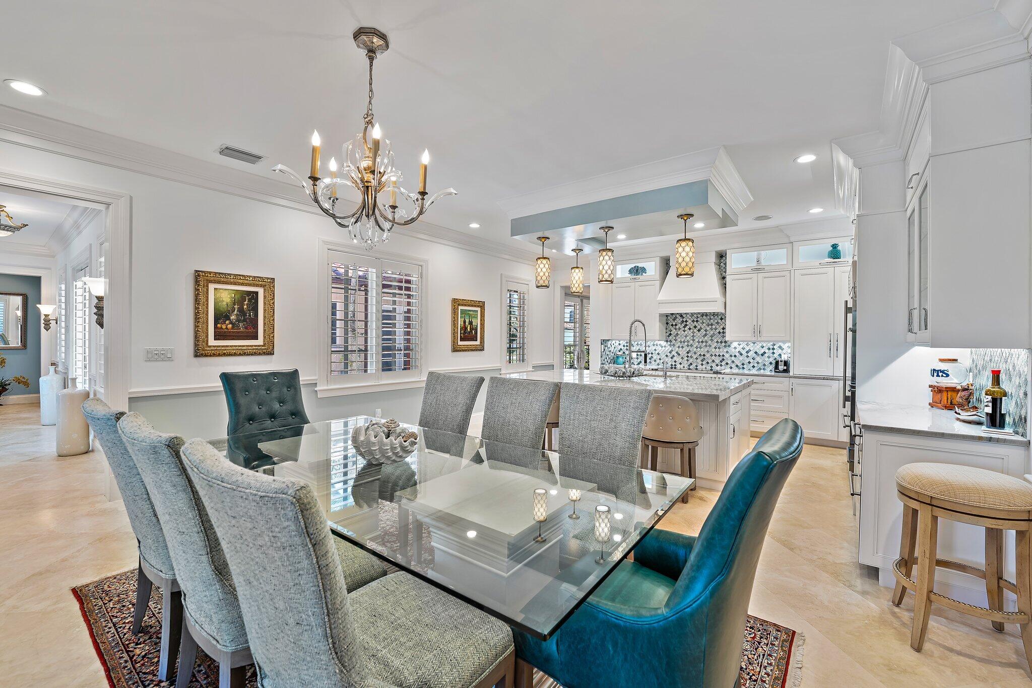 438 Red Hawk Drive Jupiter, FL 33477 - Photo 64 of 116 a view of a dining room with furniture a chandelier and wooden floor