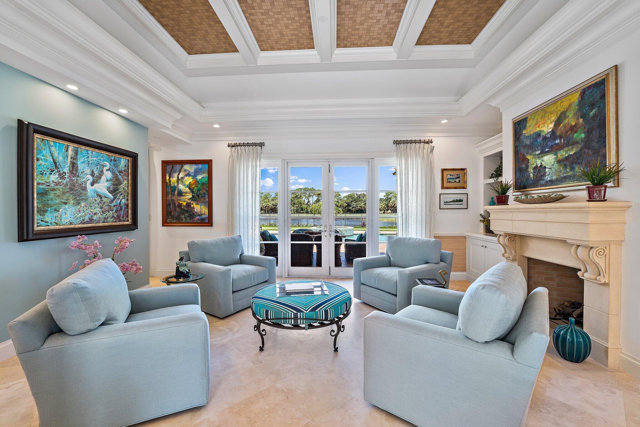 438 Red Hawk Drive Jupiter, FL 33477 - Photo 70 of 116 a living room with furniture a fireplace and a flat screen tv