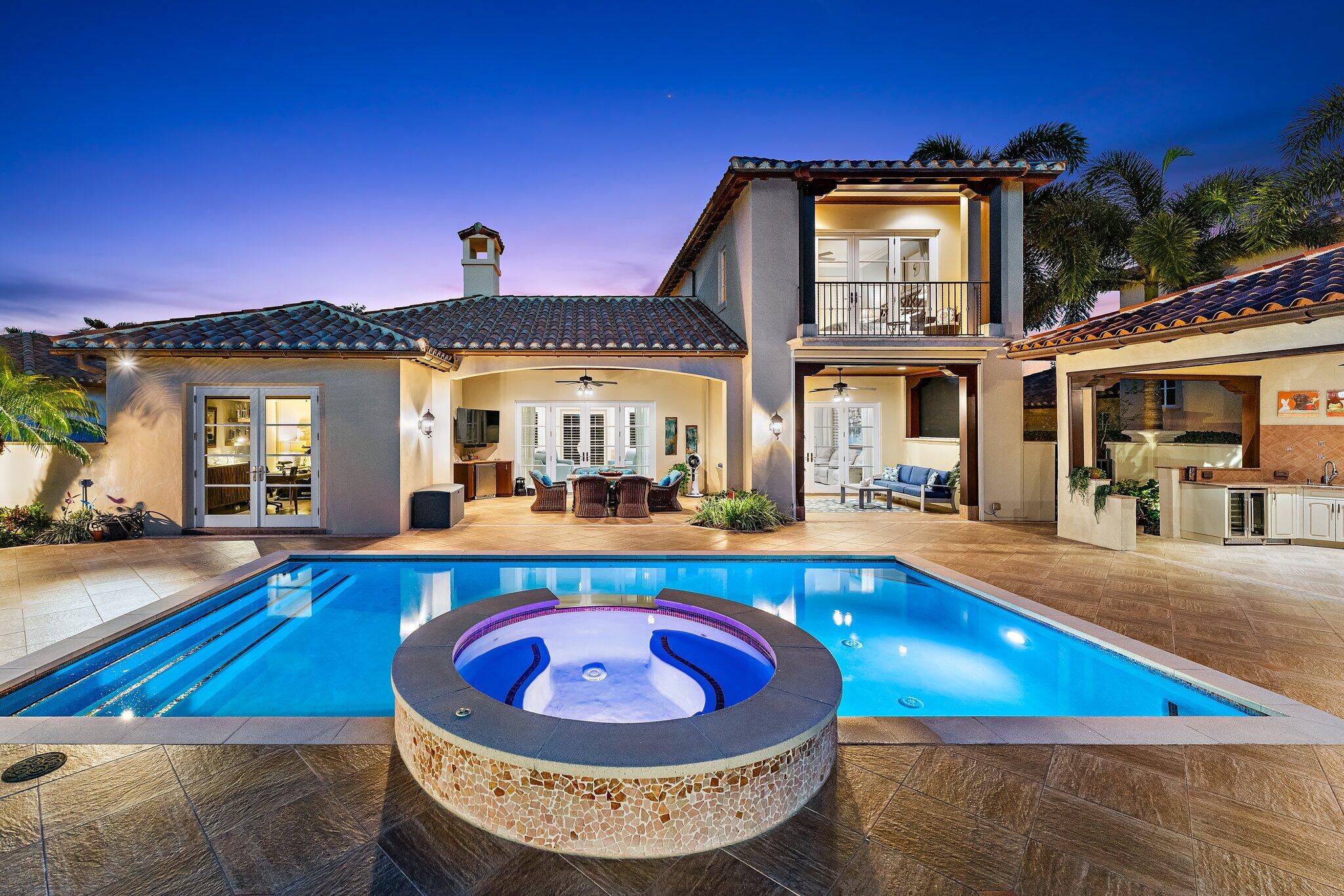 438 Red Hawk Drive Jupiter, FL 33477 - Photo 7 of 116 a view of a house with pool and chairs