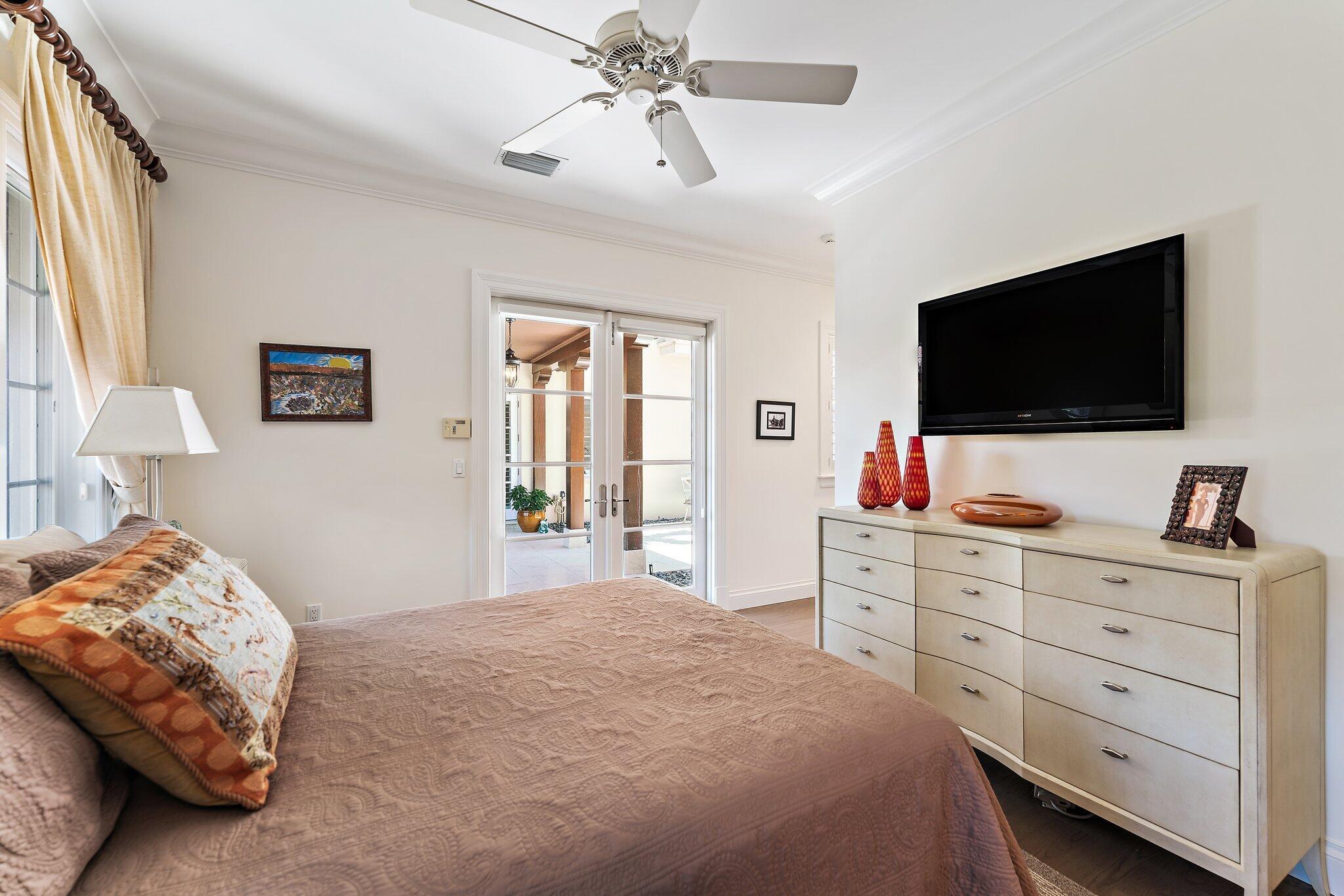 438 Red Hawk Drive Jupiter, FL 33477 - Photo 86 of 116 a bedroom with a bed and a flat screen tv