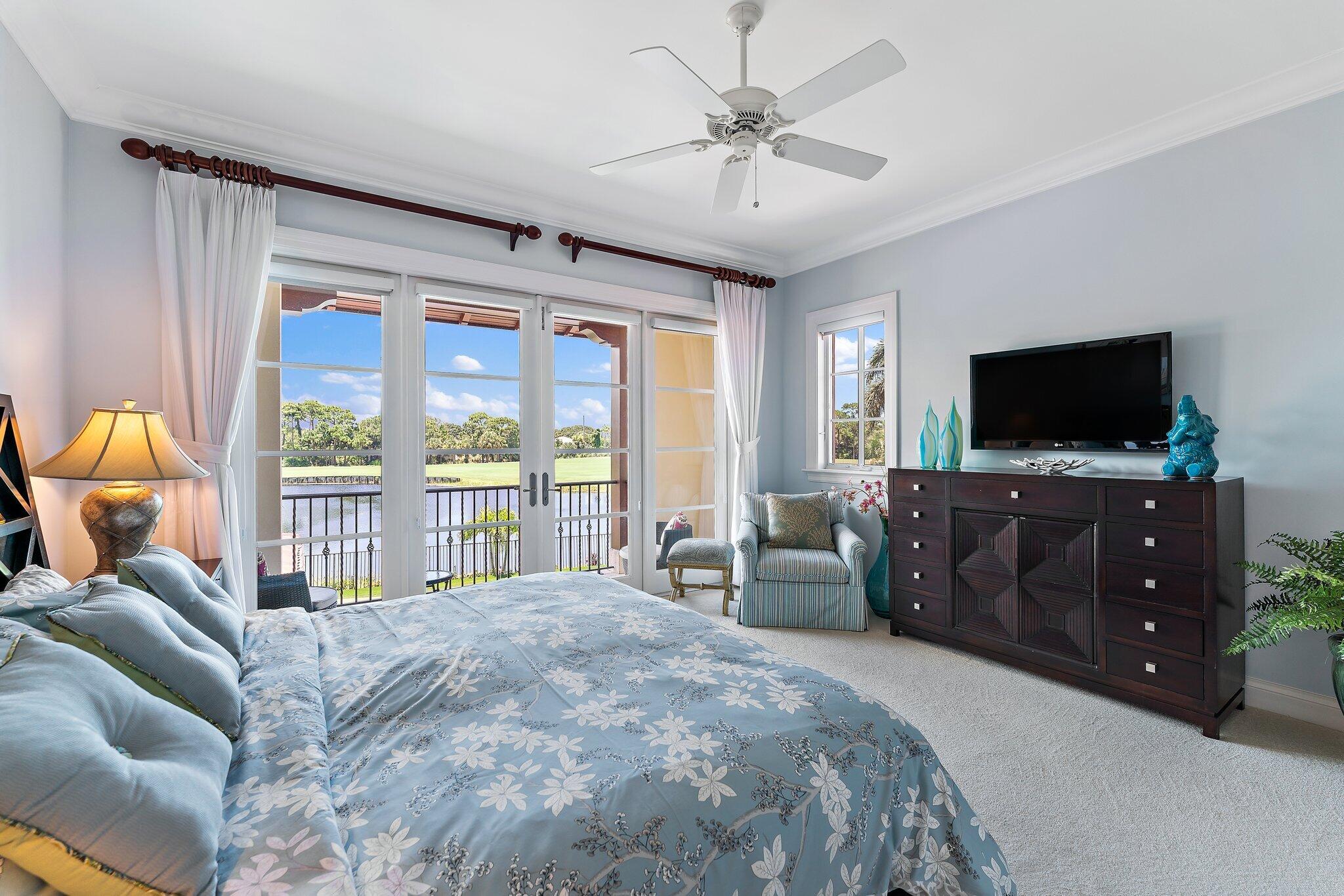 438 Red Hawk Drive Jupiter, FL 33477 - Photo 92 of 116 a bedroom with a bed and a flat tv screen on dresser
