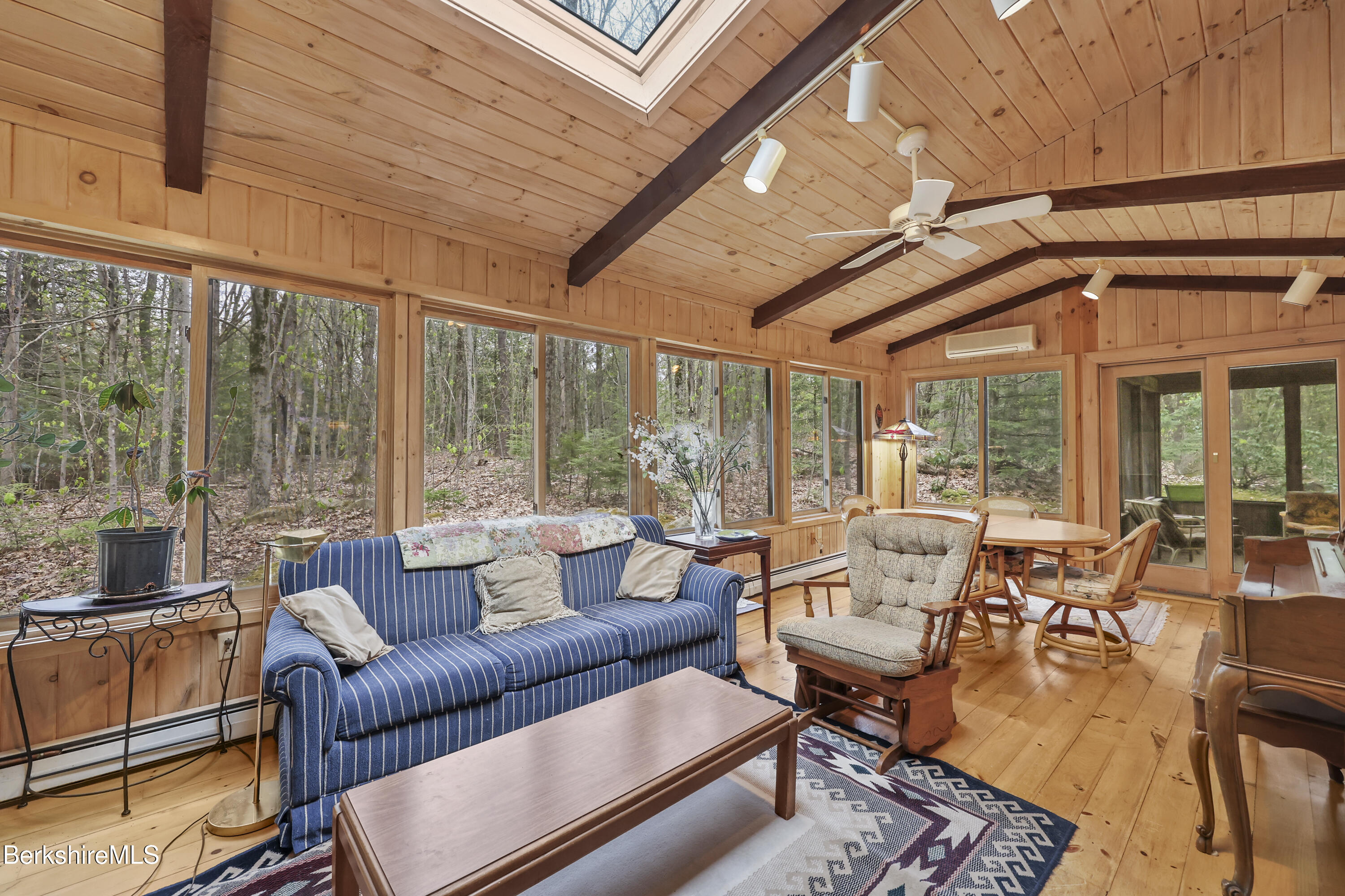 422 Bonny Rigg Hill Road Becket, MA 01223 - Photo 32 of 60 a living room with furniture and floor to ceiling windows