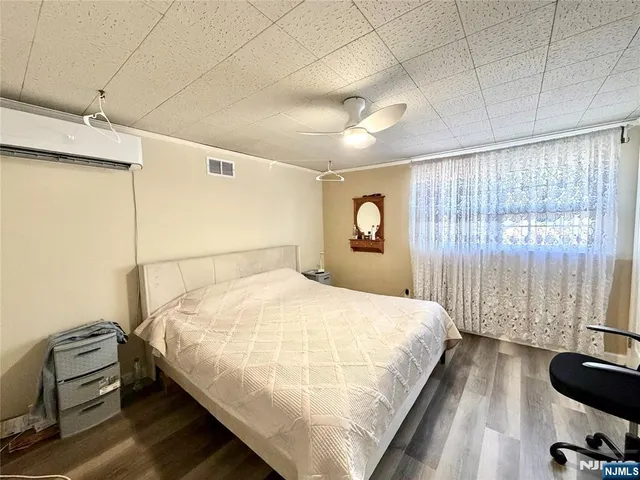 a bedroom with a bed and a large window
