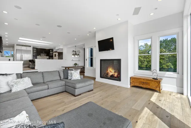 a living room with furniture tv and a floor to ceiling window
