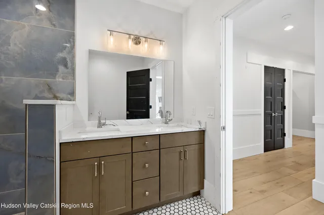 a bedroom with a bed a chandelier and a window