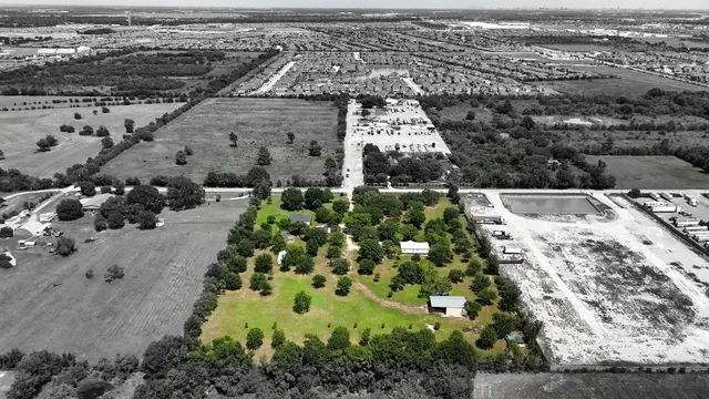 an aerial view of residential houses with outdoor space