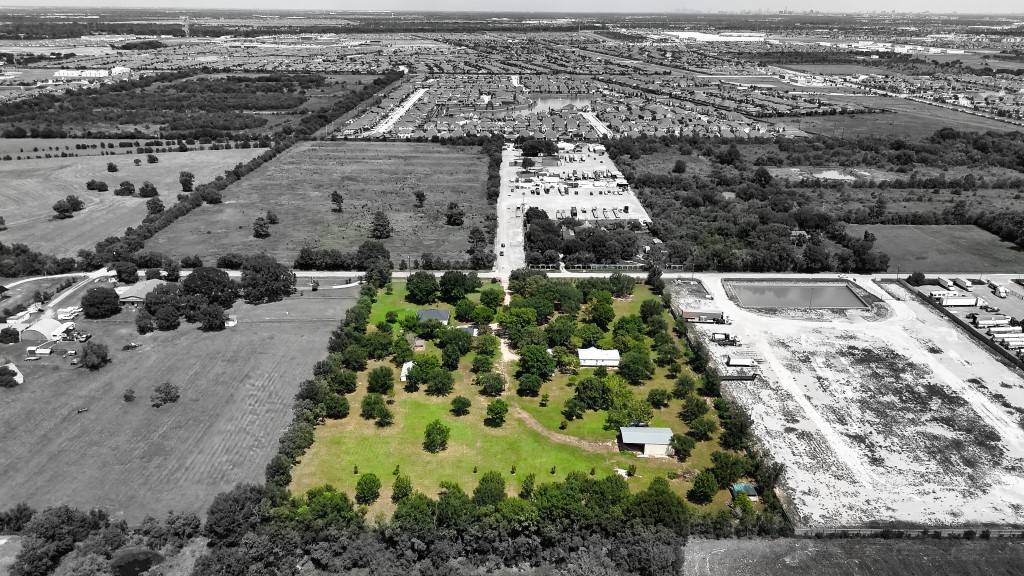 an aerial view of residential houses with outdoor space