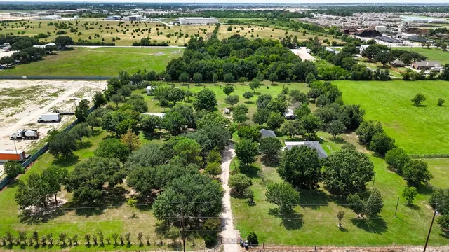 an aerial view of a houses with outdoor space and street view