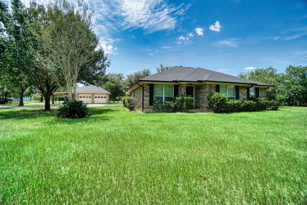 4249 Roland Road Katy, TX 77493 - Photo 5 of 12 a front view of a house with garden