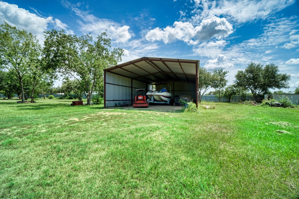 4249 Roland Road Katy, TX 77493 - Photo 9 of 12 a view of a house with backyard and trees
