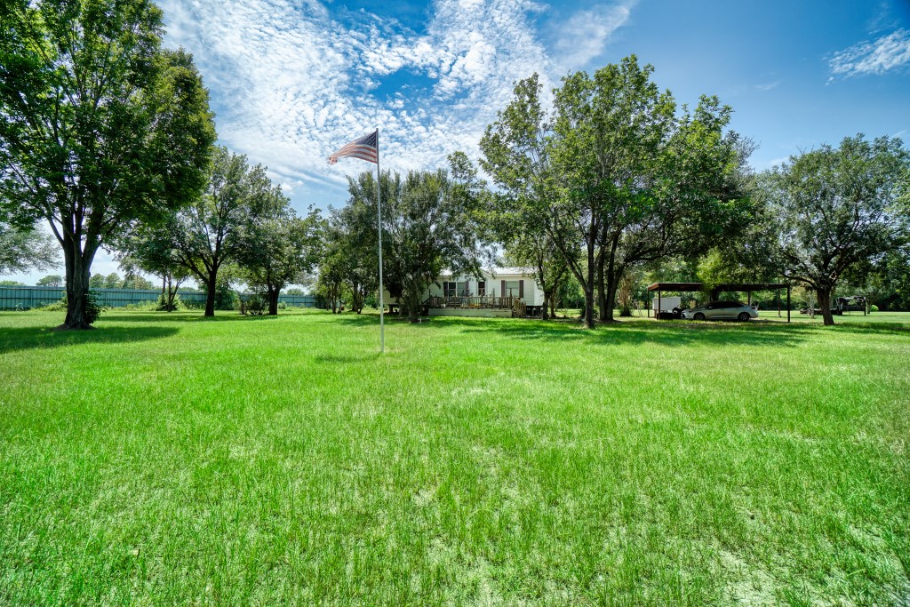 4249 Roland Road Katy, TX 77493 - Photo 10 of 12 a view of green field with trees in the background