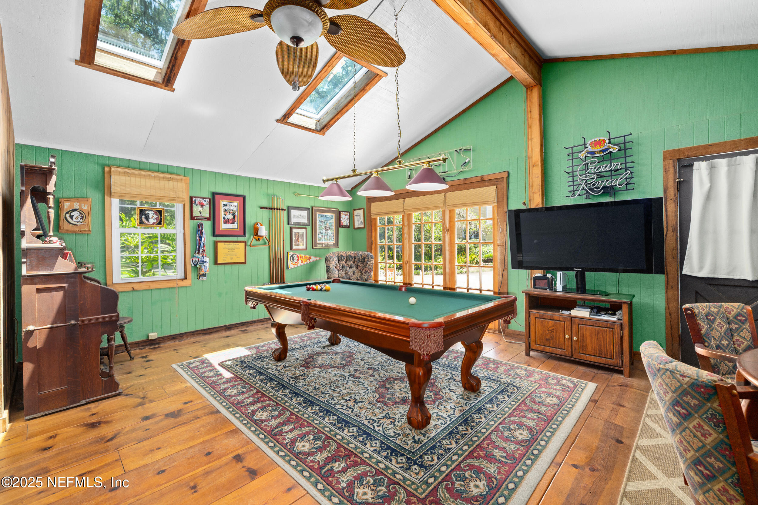 12367 Mandarin Road Jacksonville, FL 32223 - Photo 31 of 114 a living room with furniture a flat screen tv and a floor to ceiling window