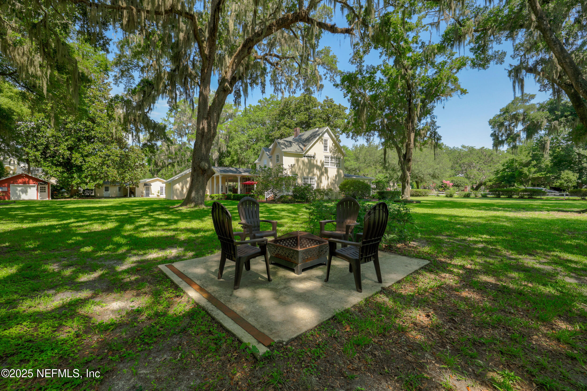 12367 Mandarin Road Jacksonville, FL 32223 - Photo 43 of 114 a view of a backyard with table and chairs potted plants and large tree