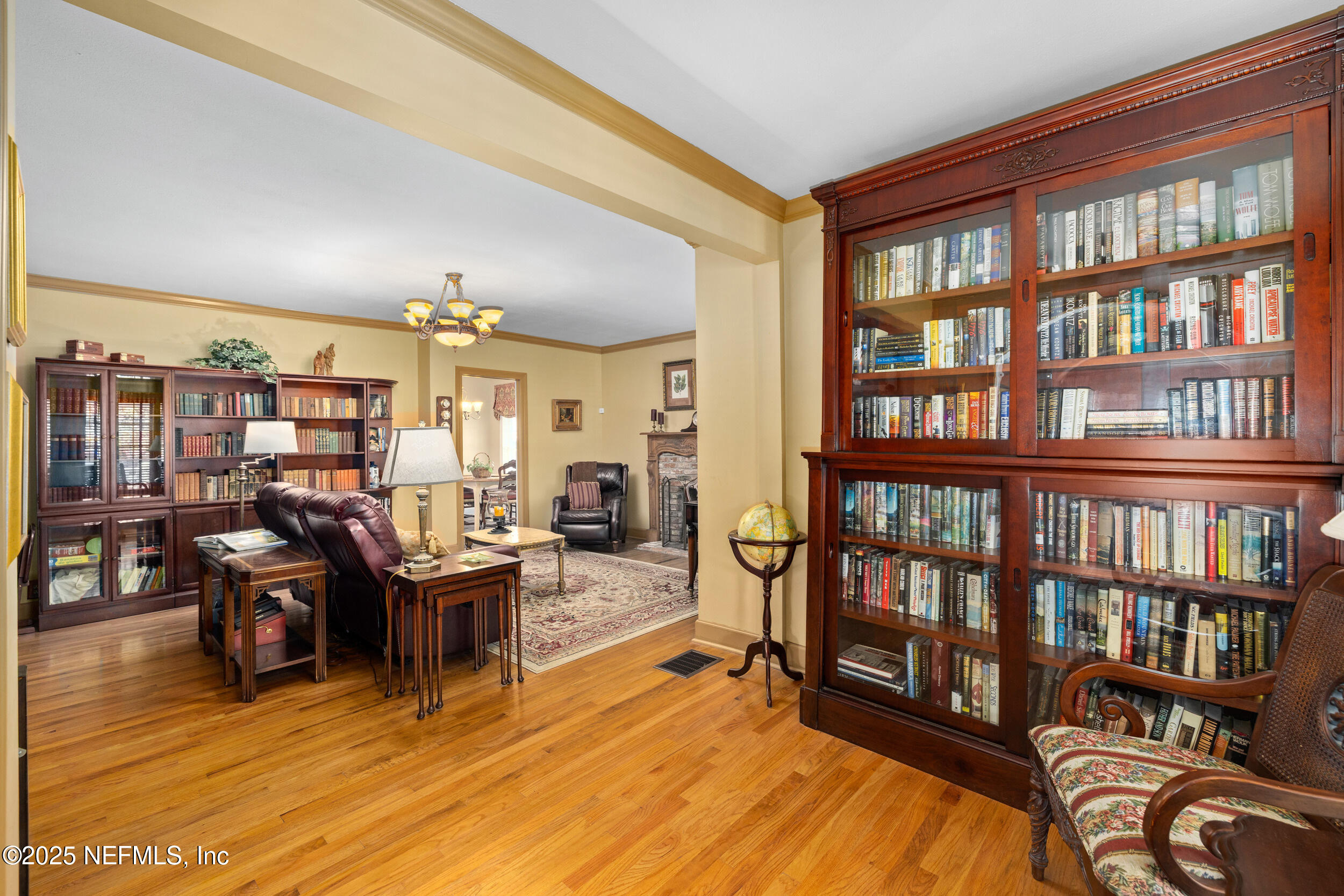 12367 Mandarin Road Jacksonville, FL 32223 - Photo 51 of 114 a living room with lots of furniture and a book shelf