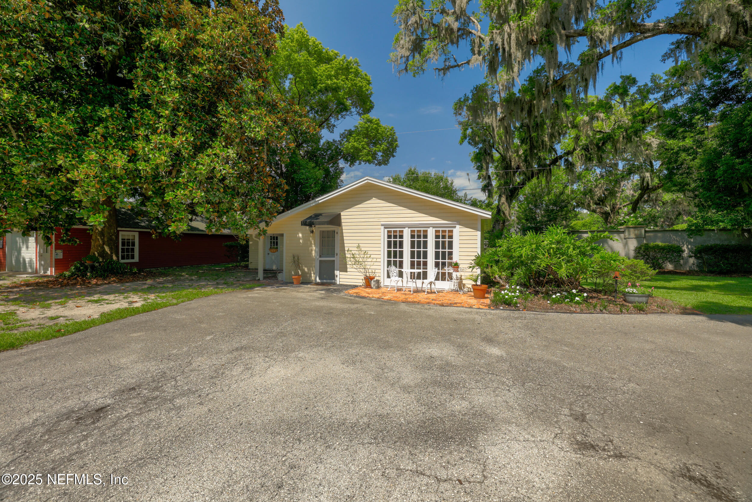 12367 Mandarin Road Jacksonville, FL 32223 - Photo 57 of 114 a view of a house with a yard and garage