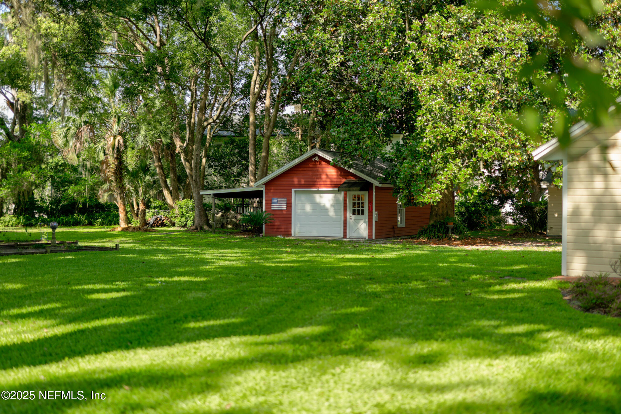 12367 Mandarin Road Jacksonville, FL 32223 - Photo 59 of 114 a view of a house with a big yard and large trees