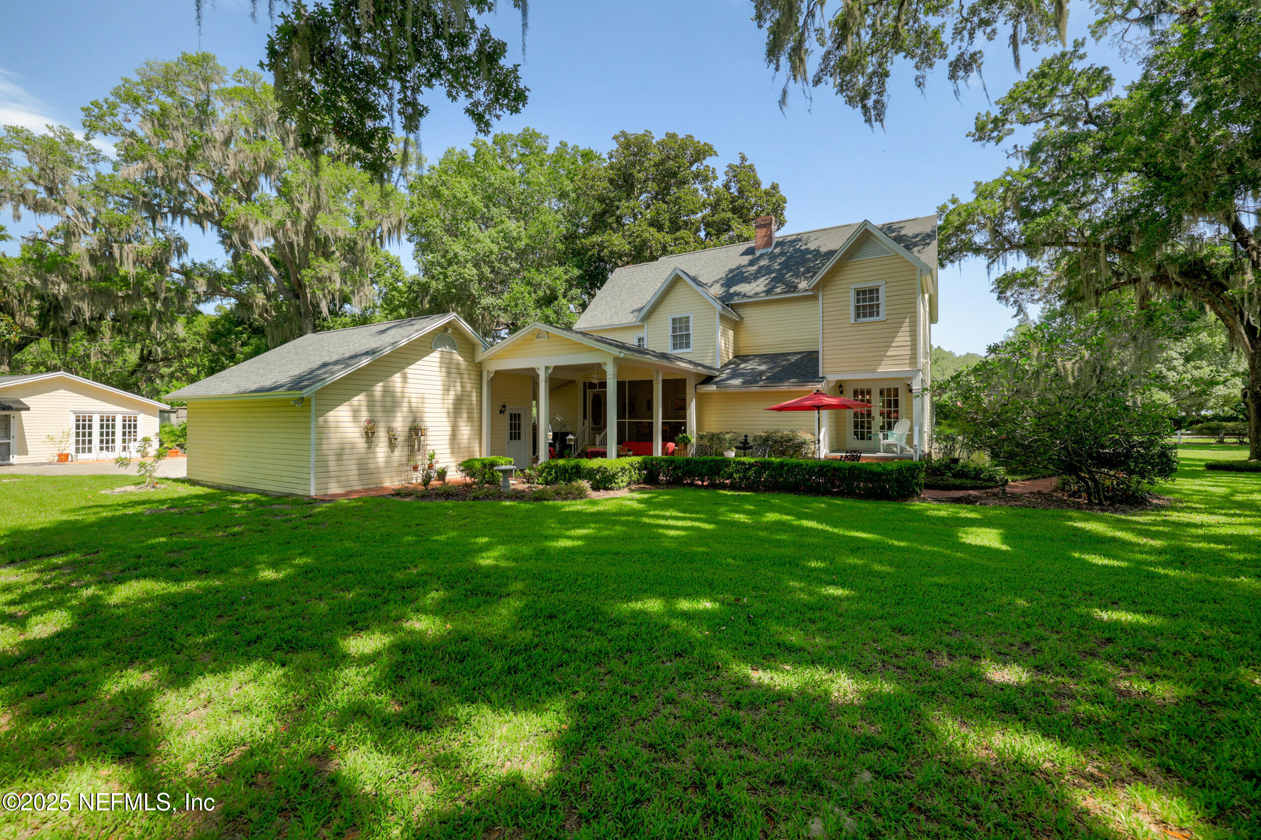 12367 Mandarin Road Jacksonville, FL 32223 - Photo 62 of 114 a front view of a house with a yard and trees