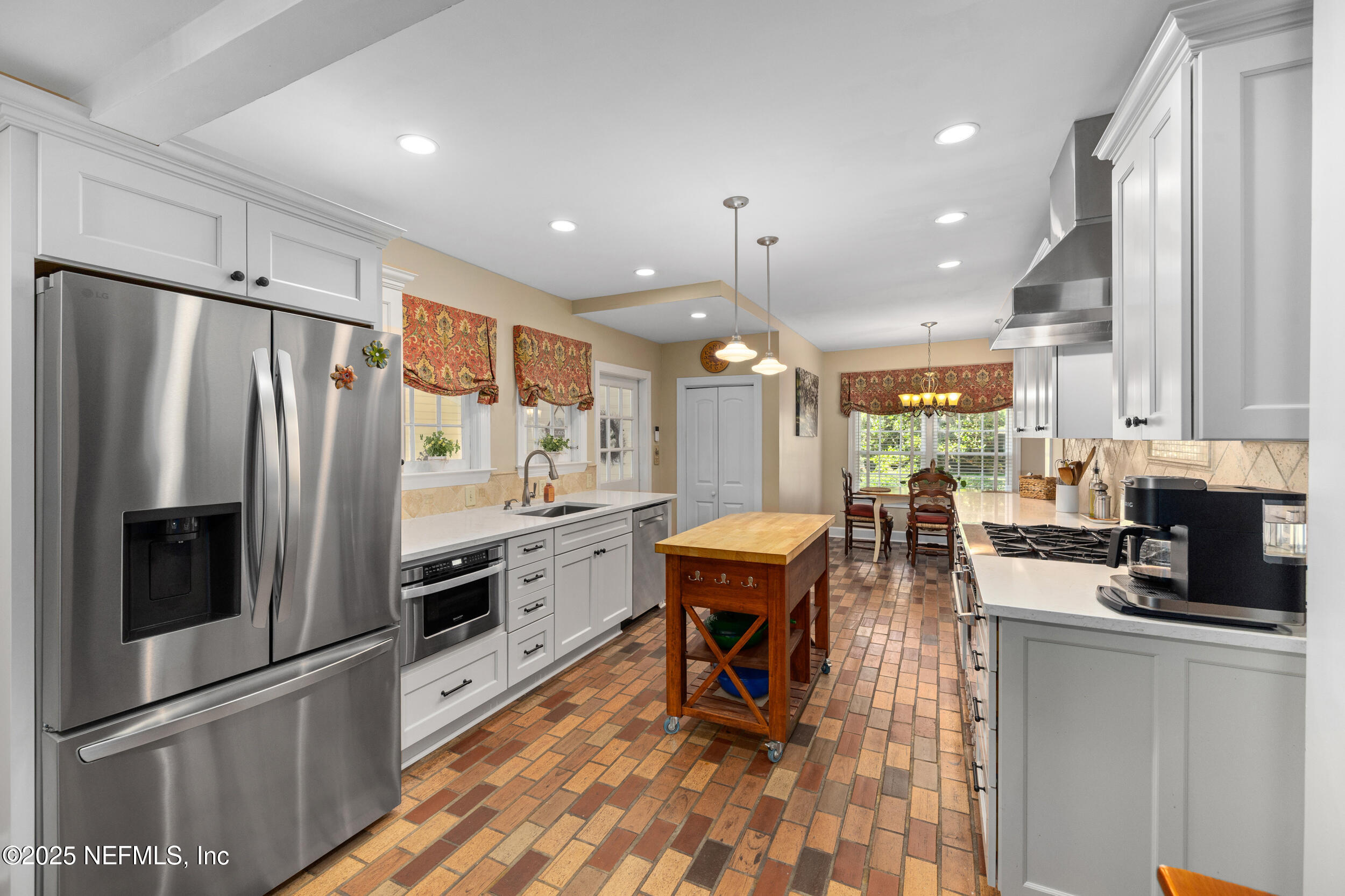 12367 Mandarin Road Jacksonville, FL 32223 - Photo 85 of 114 a kitchen with stainless steel appliances kitchen island granite countertop a refrigerator a sink a stove a dining table and chairs with wooden floor
