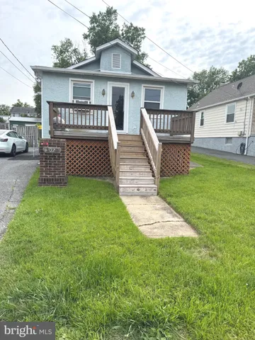 a view of a house with a yard and sitting area