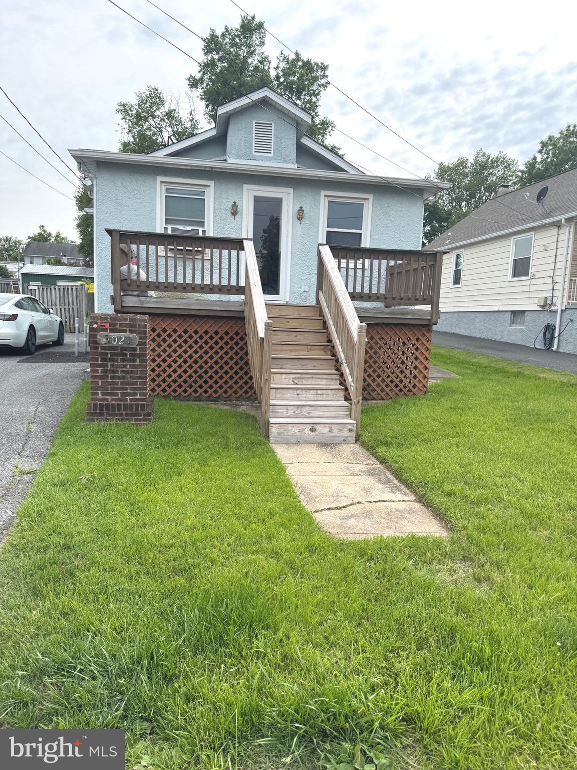 a view of a house with a yard and sitting area