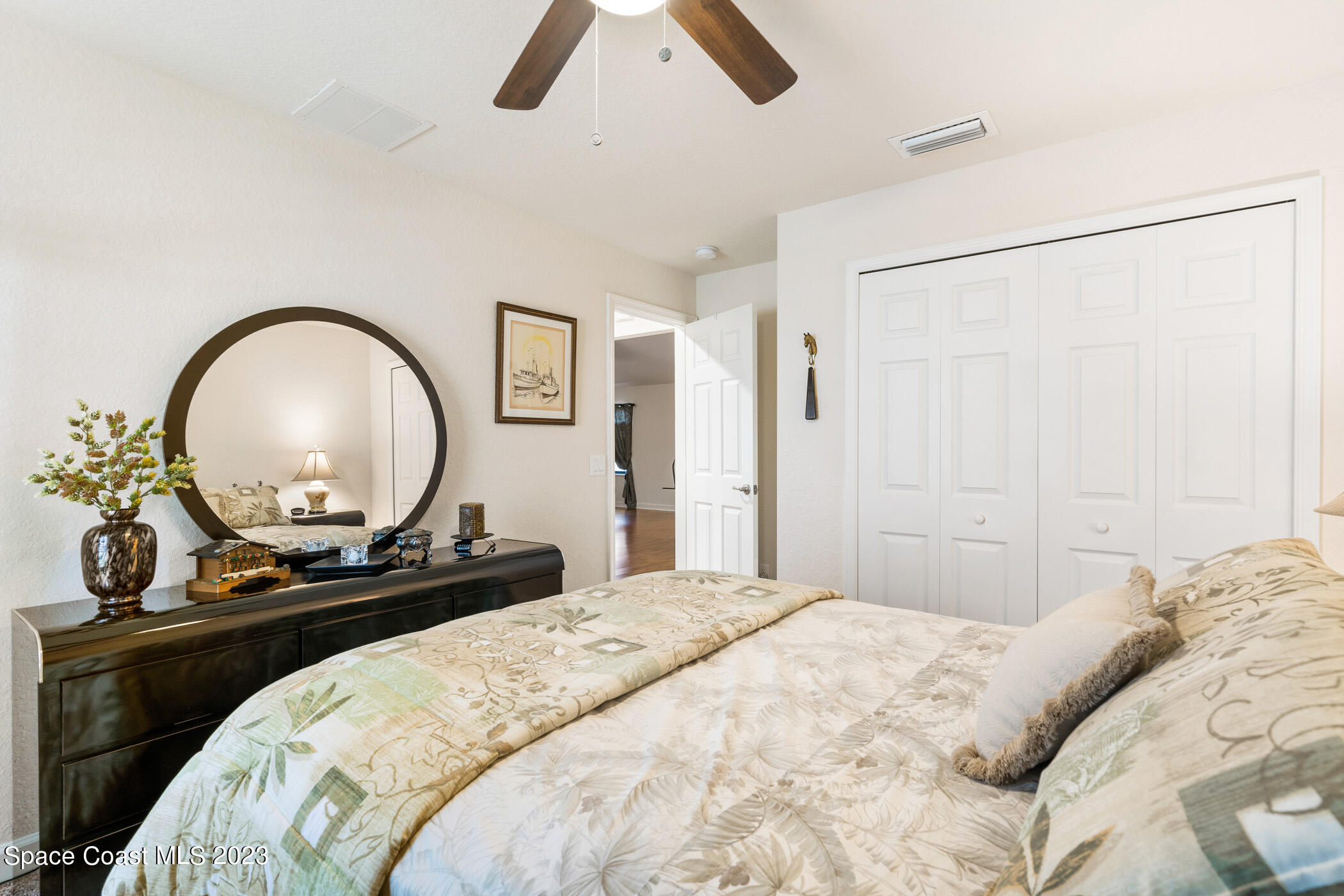 8 Danzar Fort Pierce, FL 34951 - Photo 14 of 31 a bedroom with a bed and a mirror