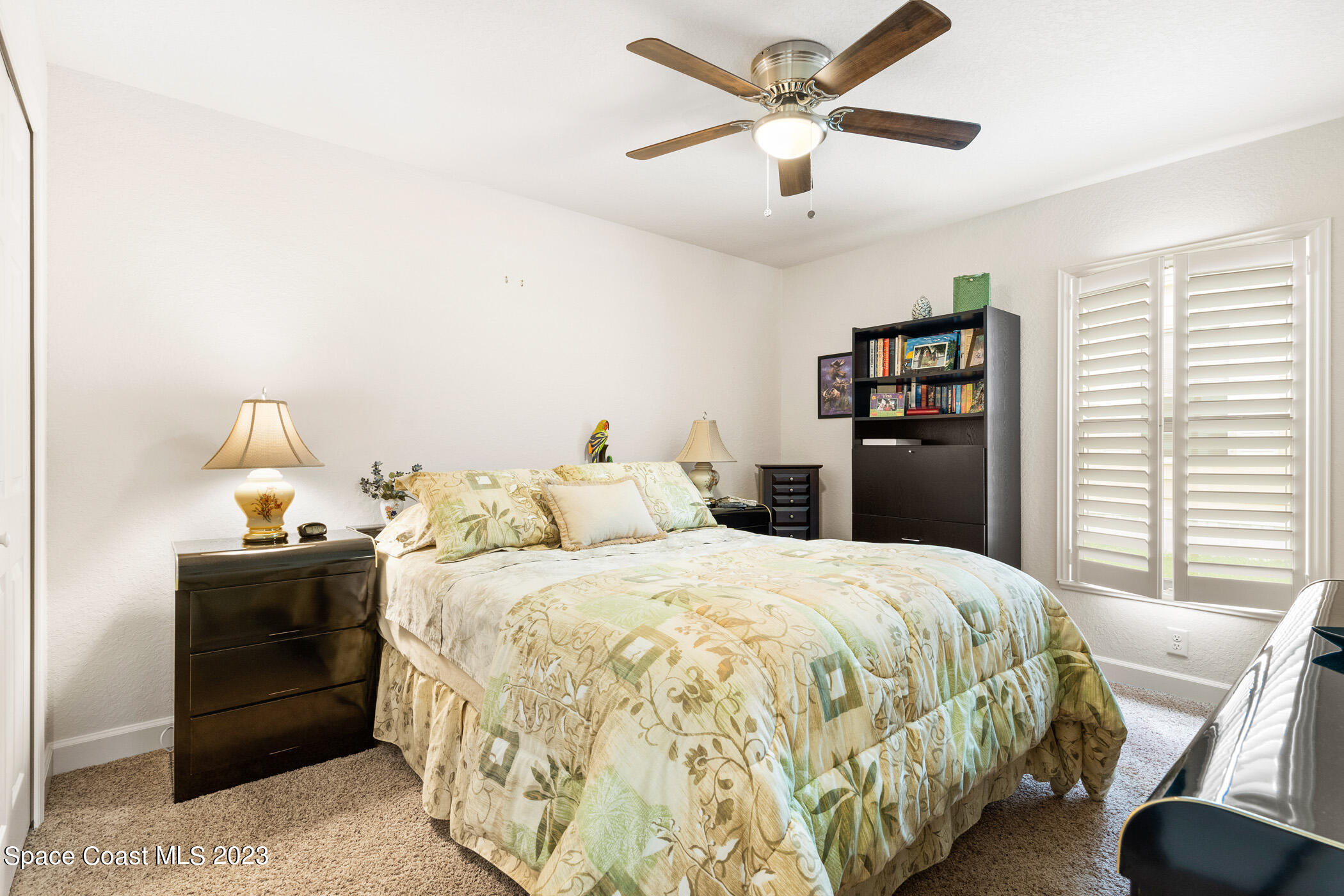 8 Danzar Fort Pierce, FL 34951 - Photo 15 of 31 a bedroom with a bed and a chandelier