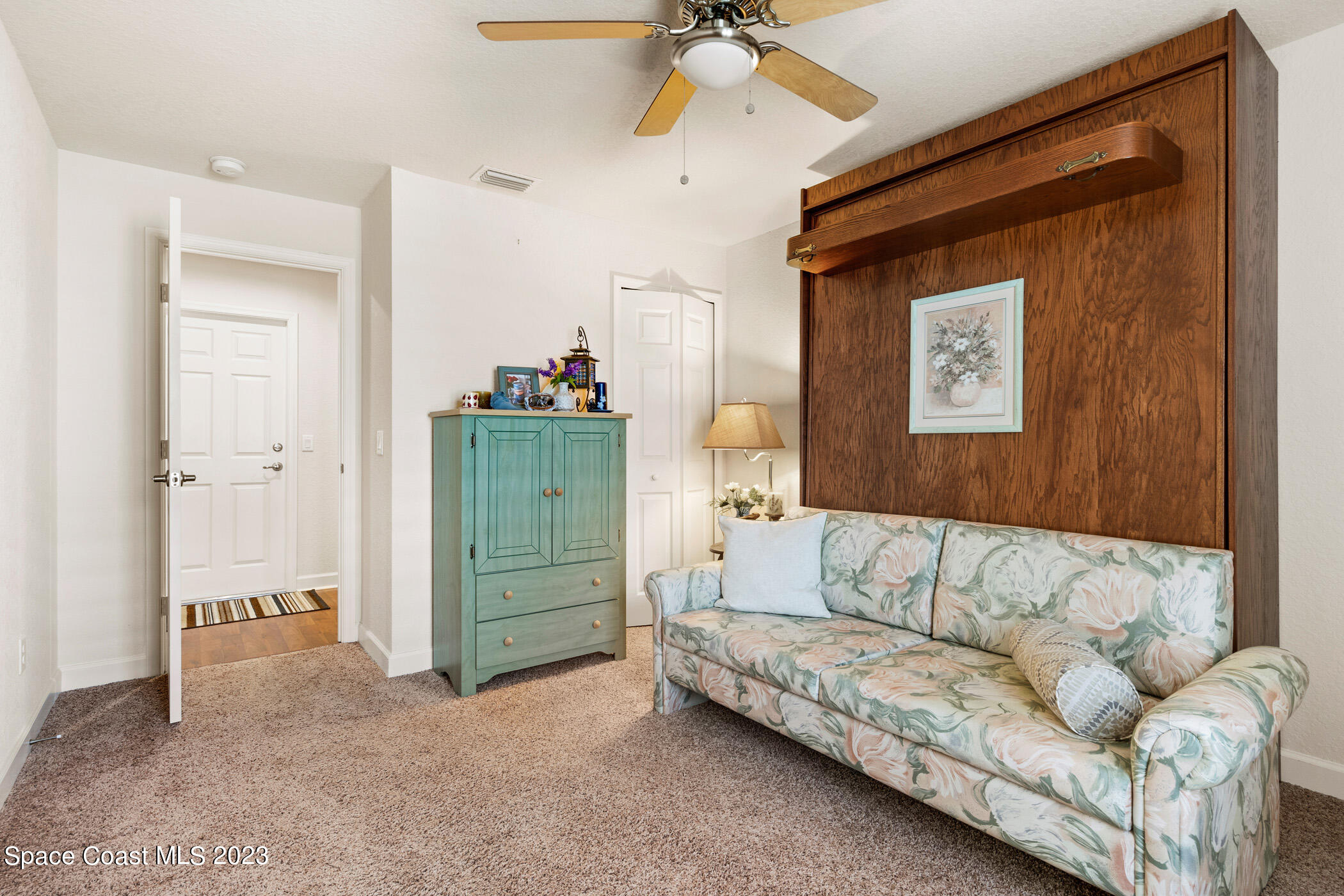 8 Danzar Fort Pierce, FL 34951 - Photo 17 of 31 a living room with furniture and a dresser