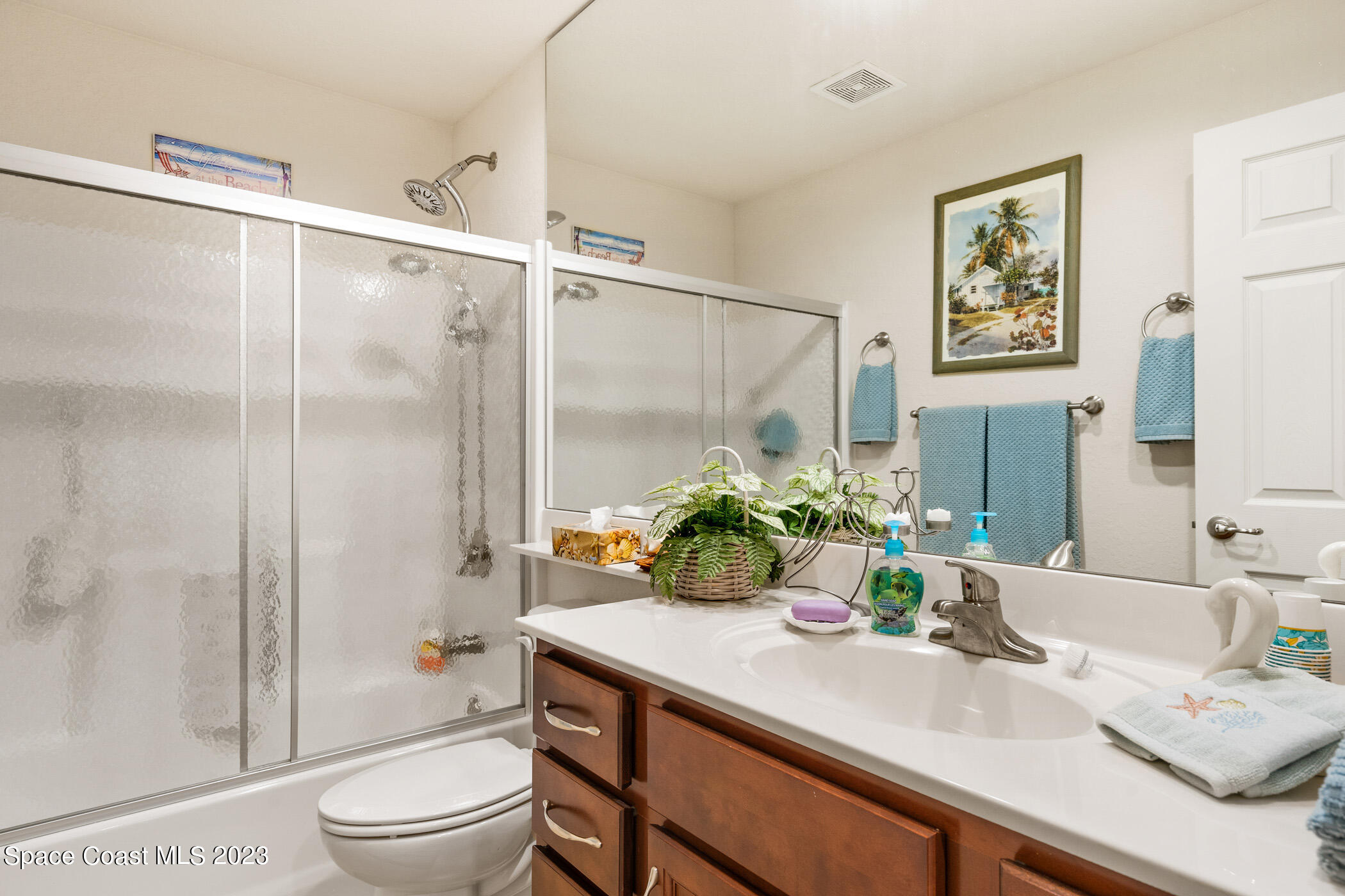 8 Danzar Fort Pierce, FL 34951 - Photo 18 of 31 a bathroom with a granite countertop sink a toilet a shower and a mirror