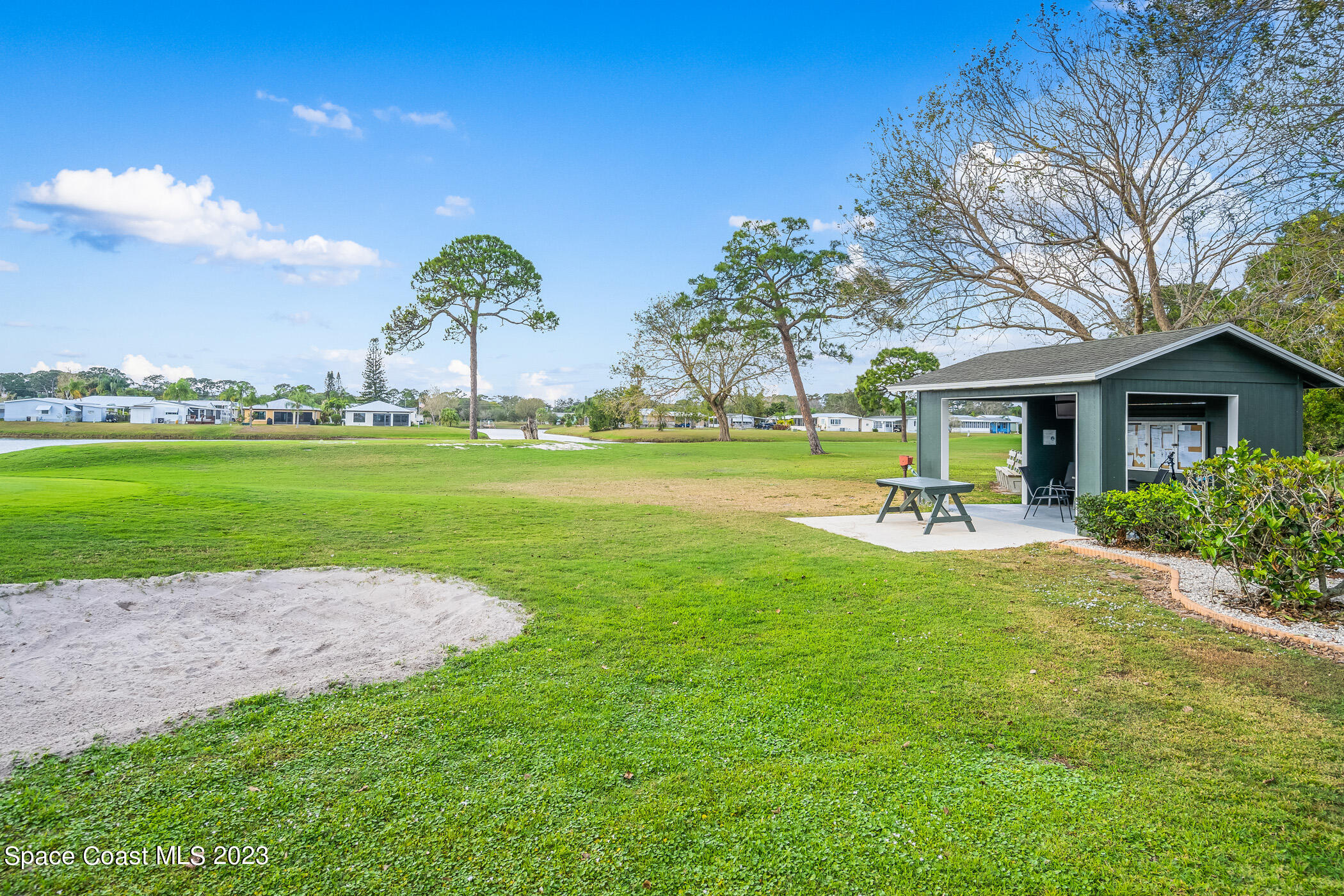 8 Danzar Fort Pierce, FL 34951 - Photo 26 of 31 a view of a house with a big yard and potted plants