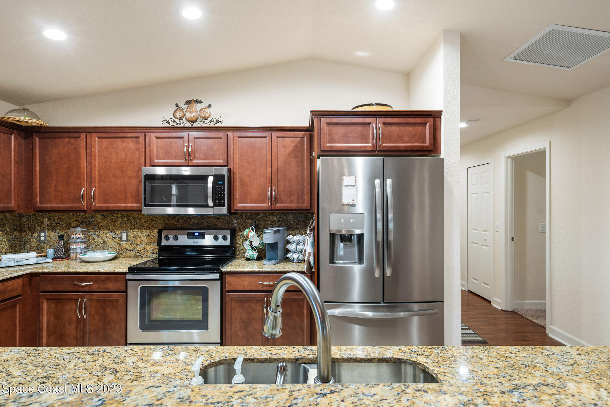 8 Danzar Fort Pierce, FL 34951 - Photo 5 of 31 a kitchen with stainless steel appliances granite countertop a stove top oven microwave and refrigerator