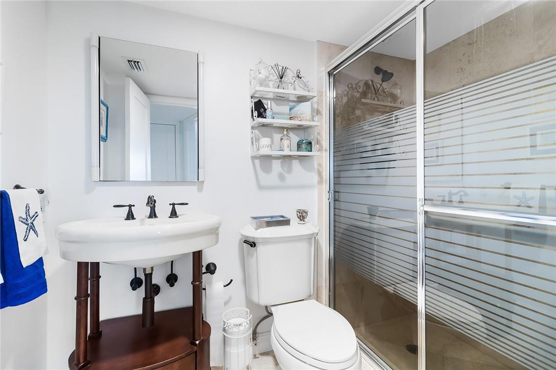 2871 North Ocean Boulevard, Unit D518 Boca Raton, FL 33431 - Photo 11 of 28 a bathroom with a sink a toilet and shower